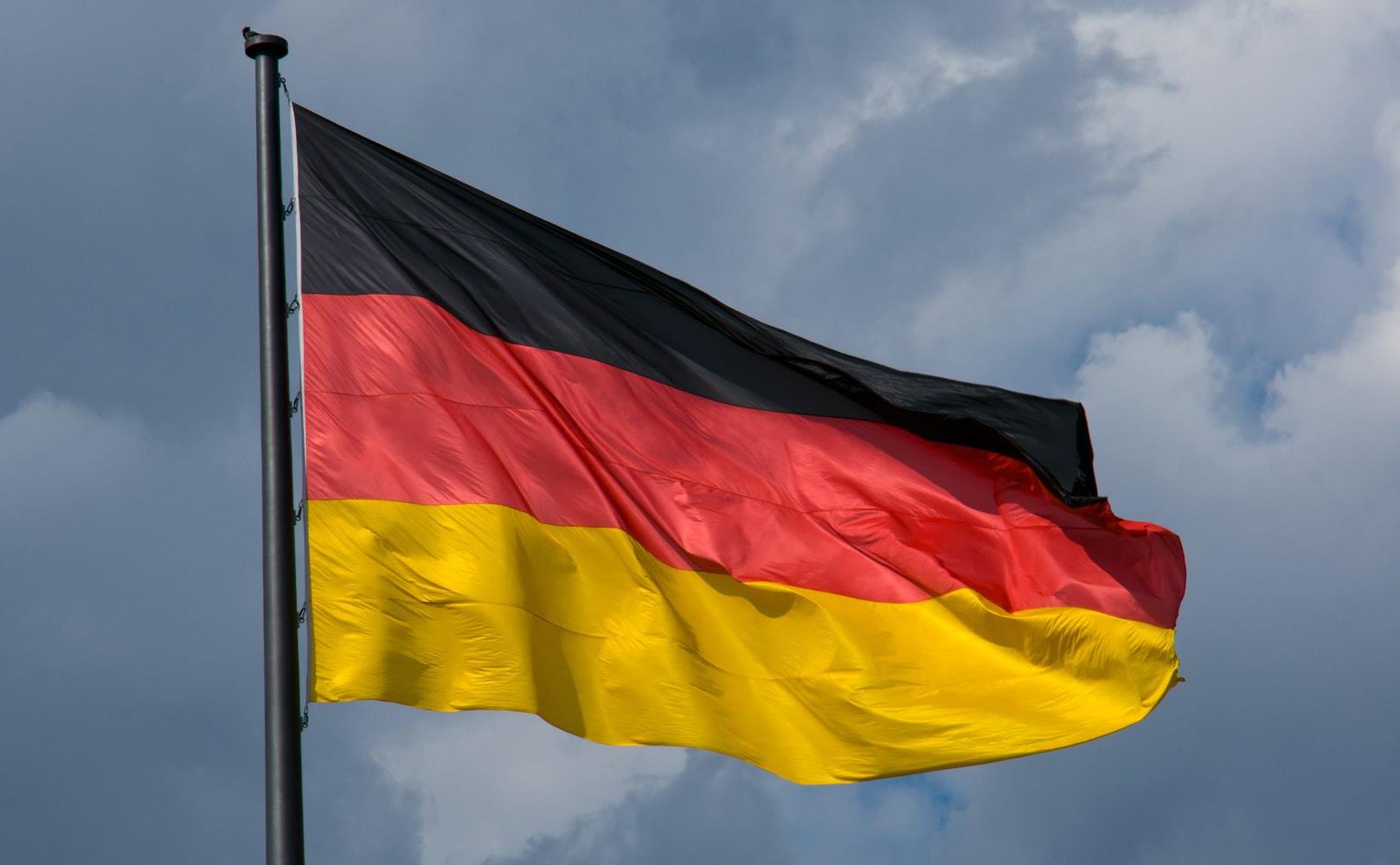 german-flag-in-front-of-dark-clouds-PDLQF4S-1800x1000.jpg
