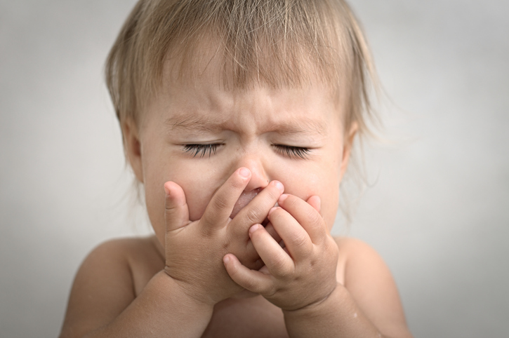 baby-crying-covering-mouth-cough.jpg