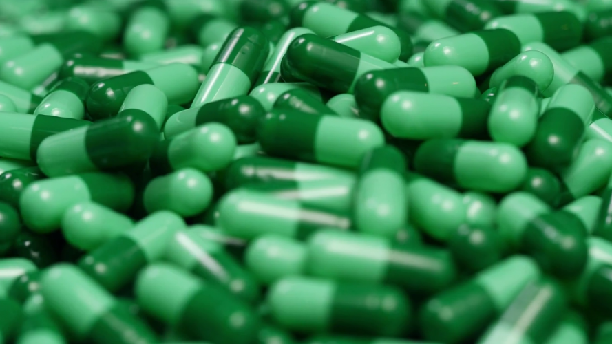 videoblocks-4k-green-pills-capsules-camera-pan_b5t857zyw_thumbnail-full01-889x500.png