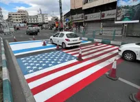 ترسیم پرچم آمریکا و رژیم صهیونیستی در کف خیابان کارگر جنوبی